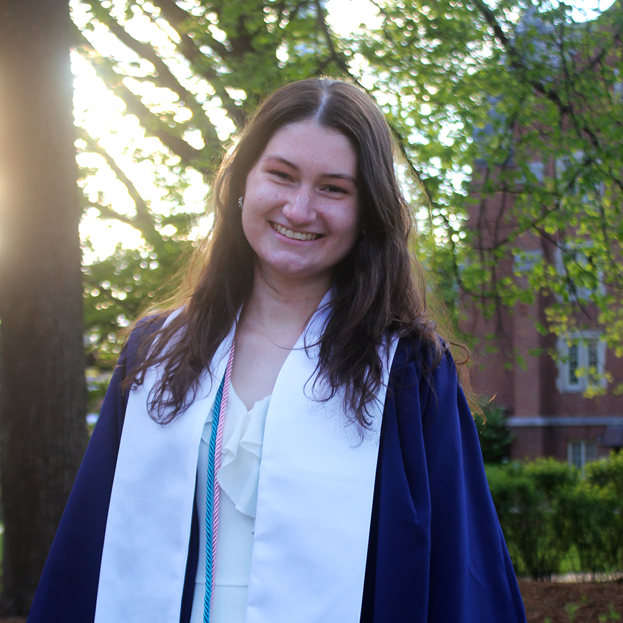 emily posing outside in her graduation regalia