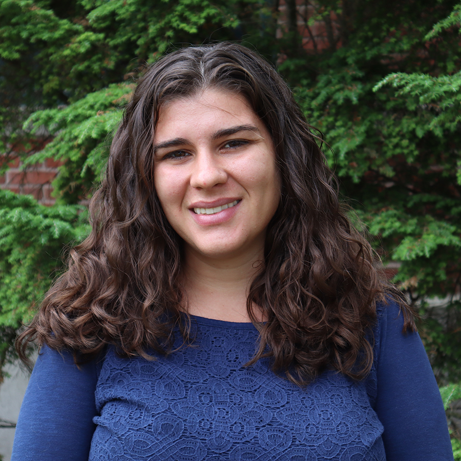 Lauren in front of green leaves